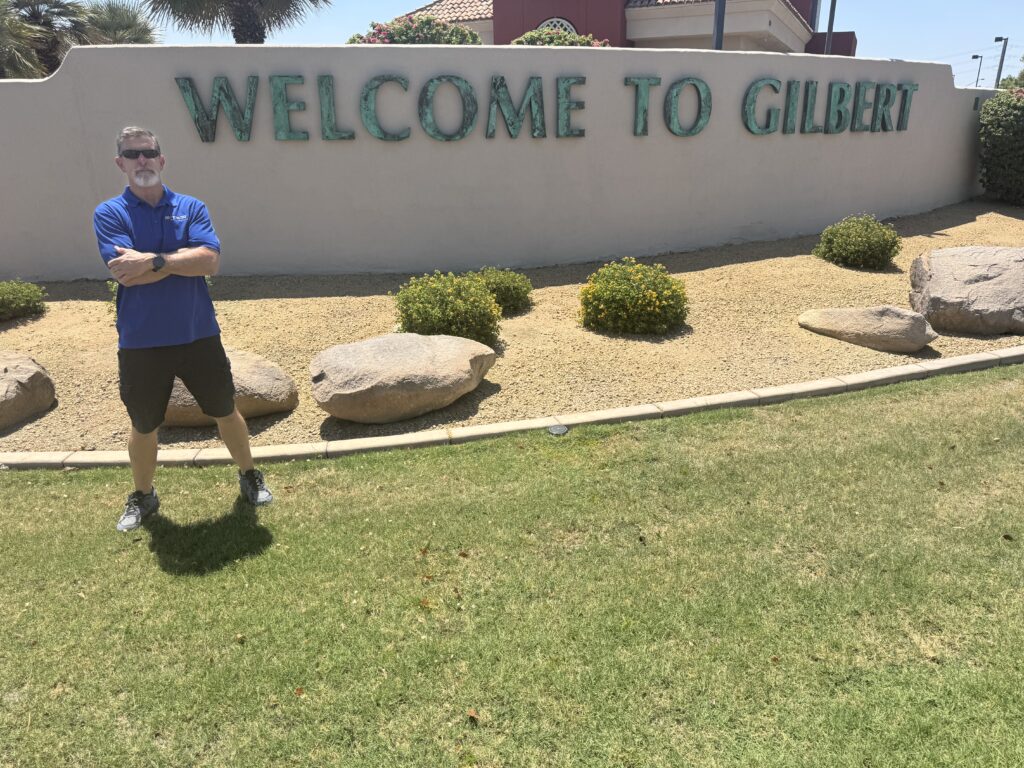 Jim McLain of Canyon State Roofing at the Welcome to Gilbert, Arizona sign